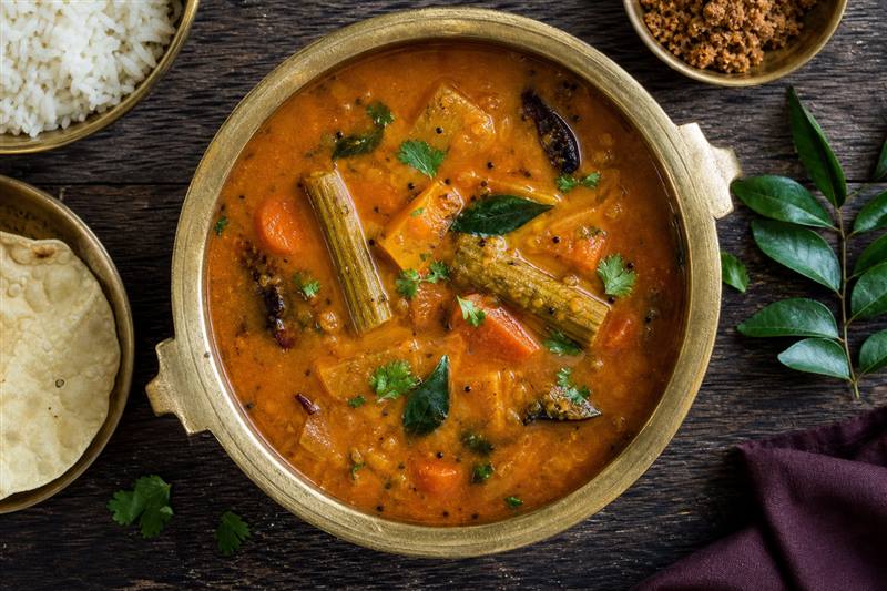 Freshly cooked South Indian sambar in a brass vessel